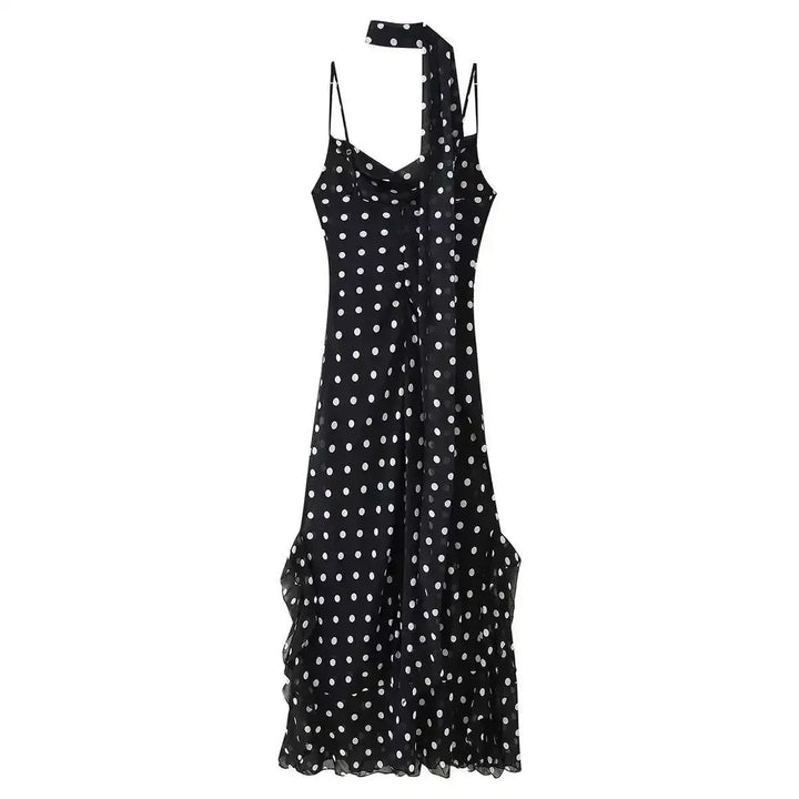 Black dress with white polka dots on a white background