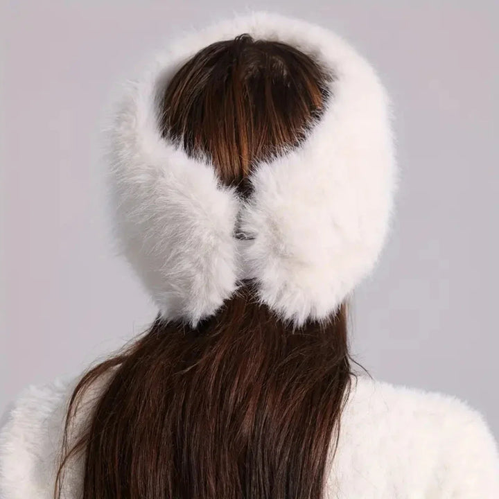 Person wearing a white fur headband against a light gray background