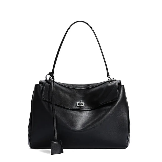Black handbag with a strap on a white background