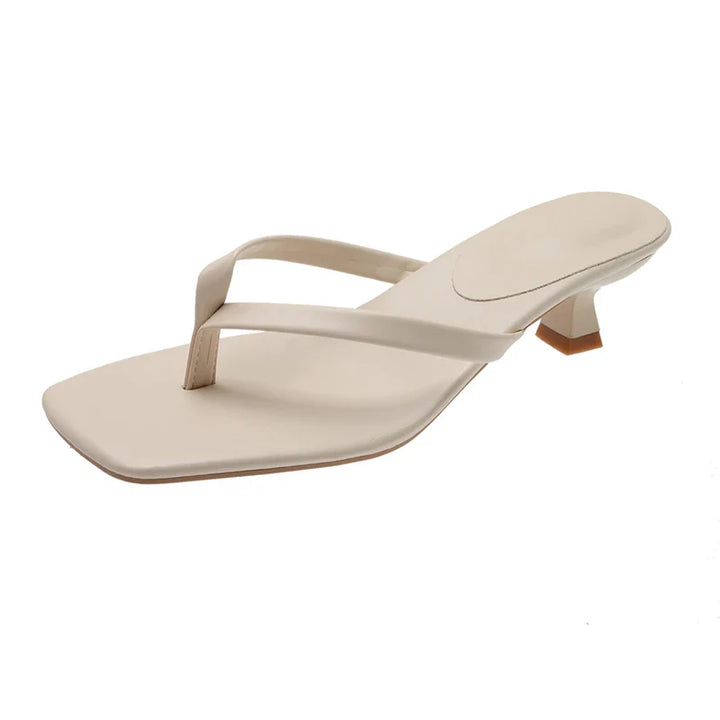 Beige sandal with a small heel on a white background