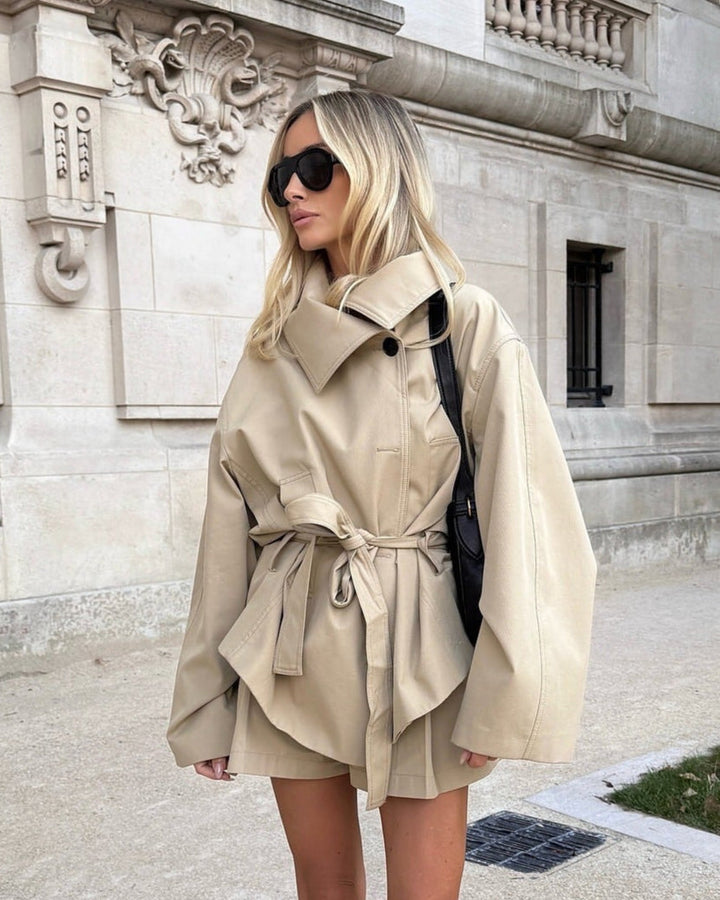 Woman wearing a beige trench coat in an urban setting
