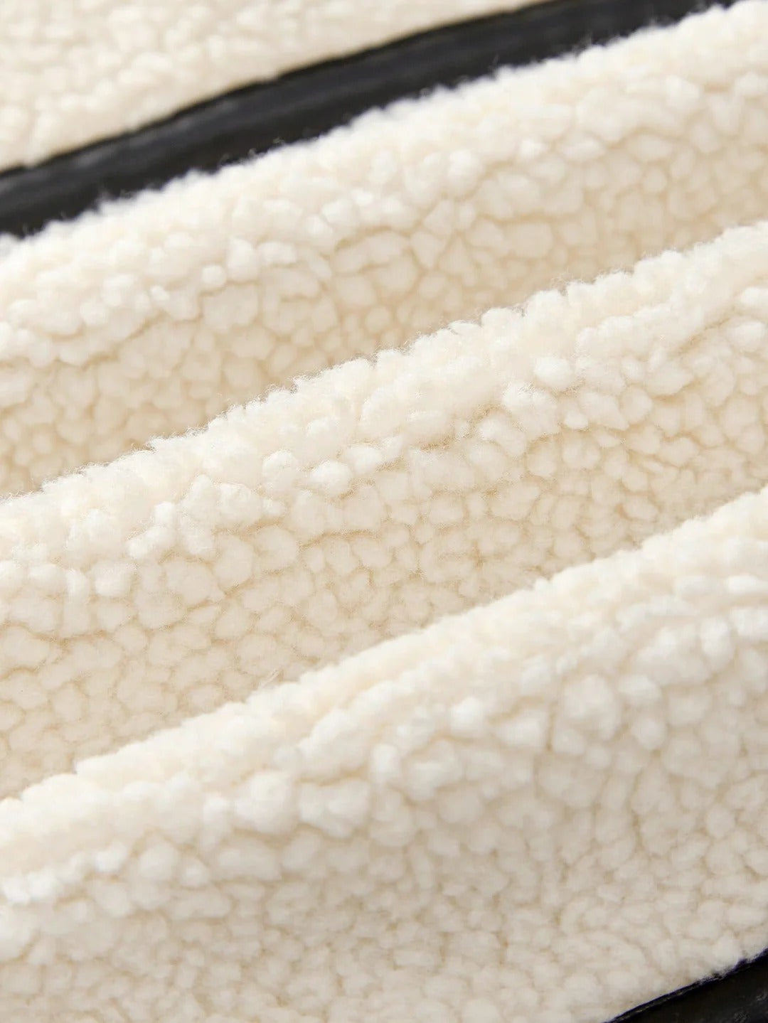 Close-up of textured white fabric with a black border