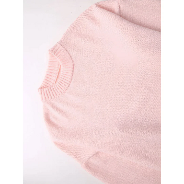 Close-up of a pink sweater on a white background